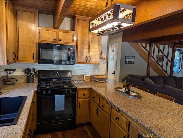 kitchen featuring dark hardwood / wood-style floors, beam ceiling, wooden ceiling, sink, and black appliances