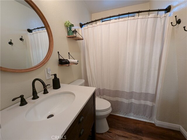 full bathroom featuring shower / tub combo with curtain, vanity, wood-type flooring, and toilet