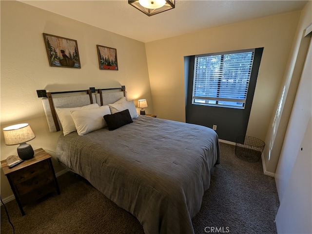 bedroom featuring dark colored carpet