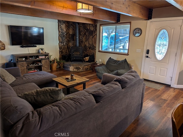 living room featuring a wood stove, wood-type flooring, wooden ceiling, and beamed ceiling