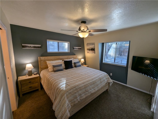 carpeted bedroom with a textured ceiling, multiple windows, a closet, and ceiling fan