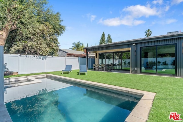 view of swimming pool with a patio area and a yard