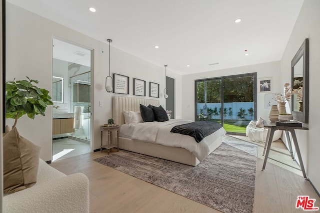 bedroom featuring access to exterior and light wood-type flooring