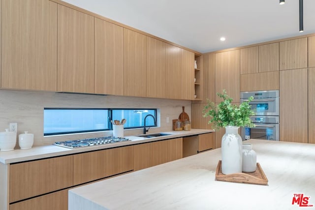 kitchen with sink, stainless steel appliances, and light brown cabinetry