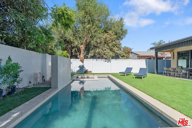 view of pool with a yard