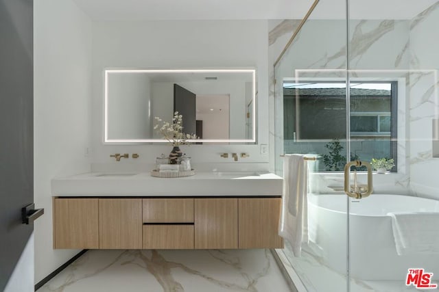 bathroom with a washtub and vanity