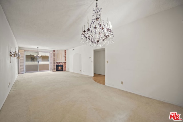 unfurnished living room featuring carpet flooring and a brick fireplace