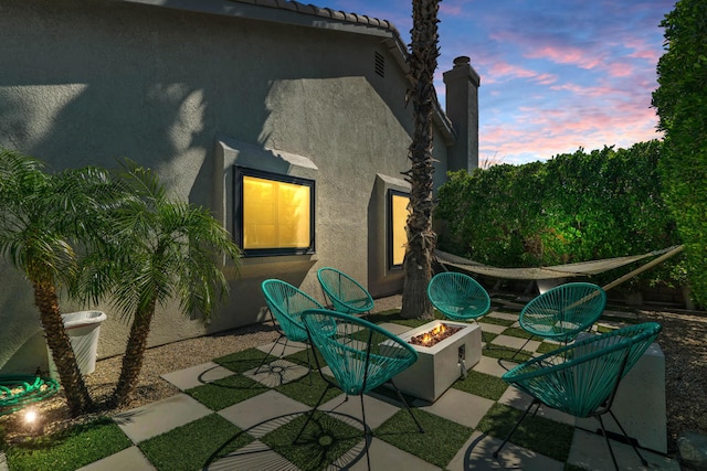 patio terrace at dusk with an outdoor fire pit