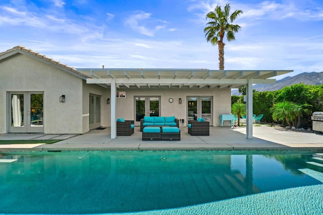 view of pool featuring a patio, a mountain view, outdoor lounge area, and a pergola