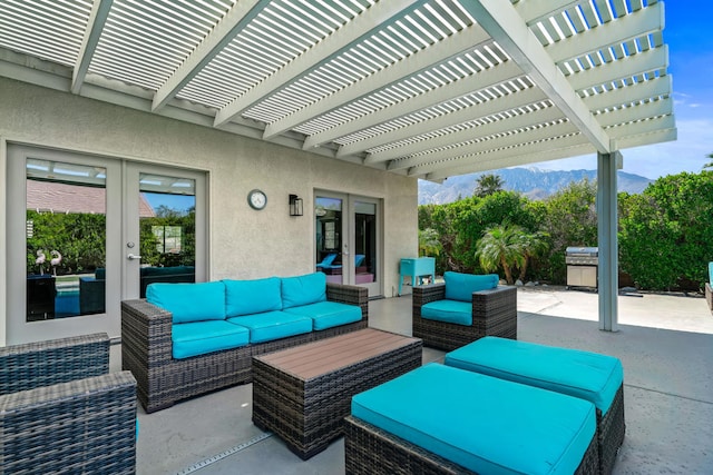 view of patio / terrace featuring french doors, an outdoor living space, a mountain view, and a pergola