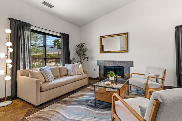 living room with lofted ceiling and a fireplace