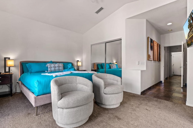 carpeted bedroom featuring lofted ceiling and a closet