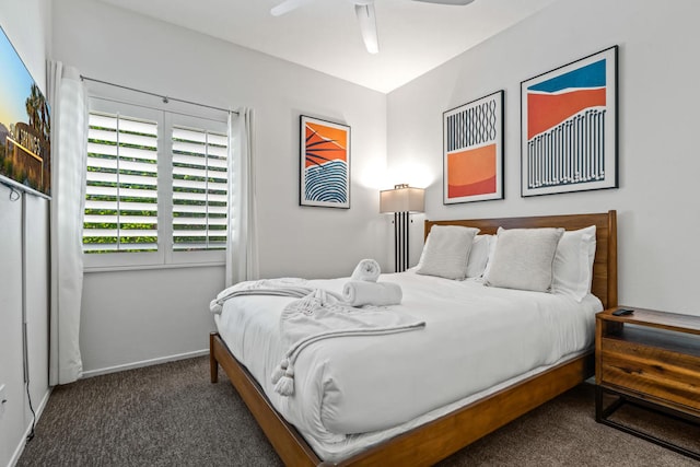 bedroom with dark colored carpet and ceiling fan