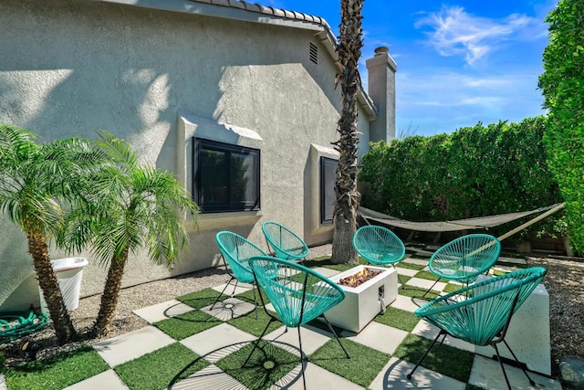 view of patio / terrace featuring an outdoor fire pit