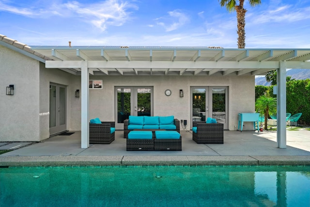 view of swimming pool with outdoor lounge area, a patio, and french doors