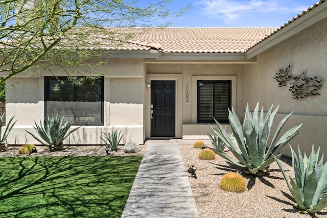 doorway to property with a lawn