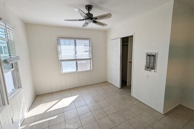 unfurnished bedroom with ceiling fan, a closet, and light tile patterned floors