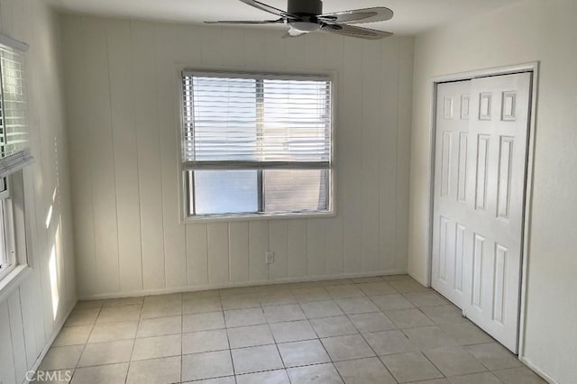 tiled empty room with ceiling fan