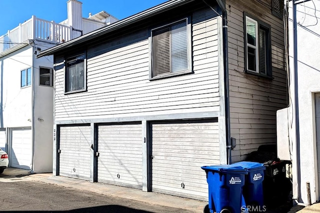 view of side of home featuring a garage