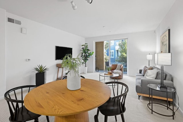 dining room featuring light colored carpet