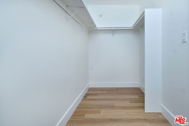 walk in closet featuring light hardwood / wood-style flooring