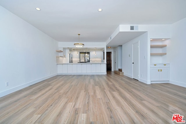 unfurnished living room with light wood-type flooring