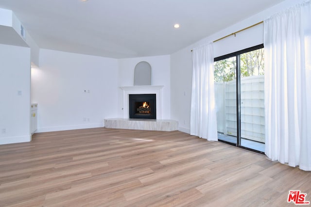 unfurnished living room with light hardwood / wood-style flooring