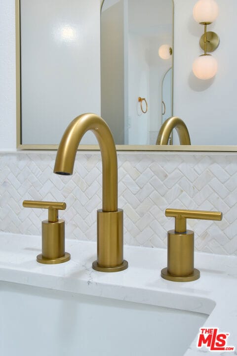 room details featuring decorative backsplash and sink