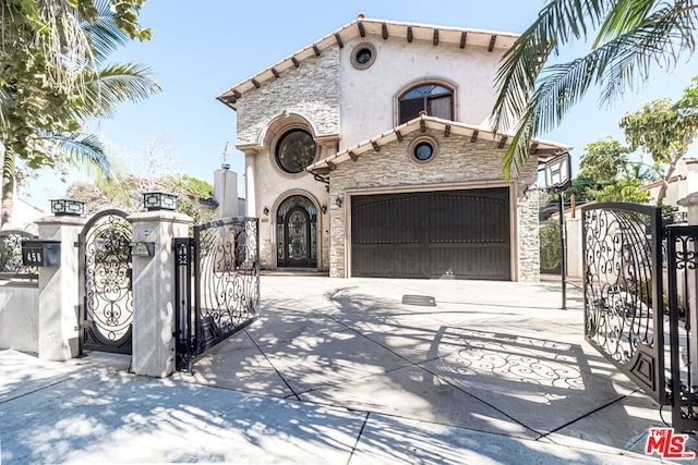 mediterranean / spanish house featuring a garage