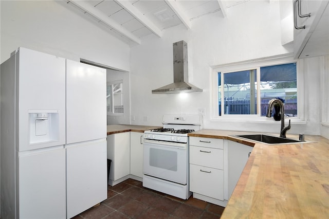 kitchen featuring extractor fan, beamed ceiling, sink, white cabinets, and white appliances