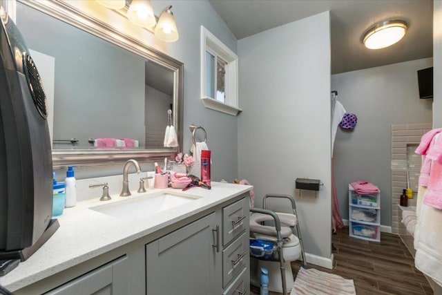 bathroom with hardwood / wood-style floors and vanity