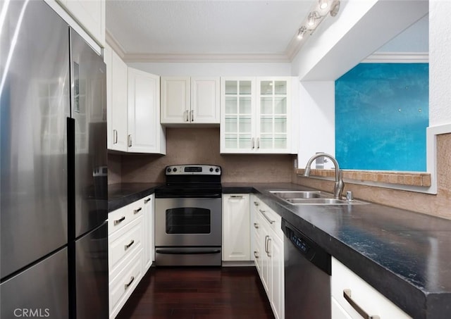 kitchen featuring dark hardwood / wood-style flooring, sink, white cabinets, and stainless steel appliances