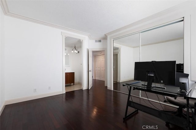 office area featuring hardwood / wood-style flooring, ornamental molding, and an inviting chandelier