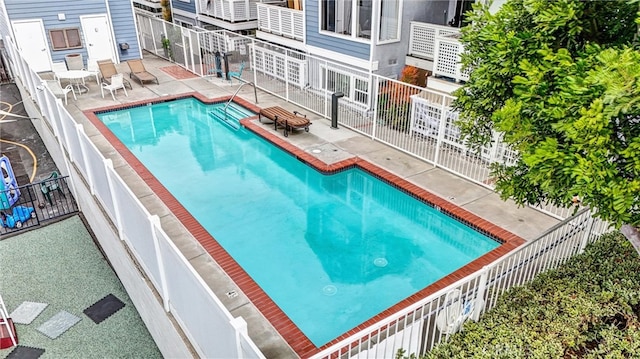 view of swimming pool featuring a patio area