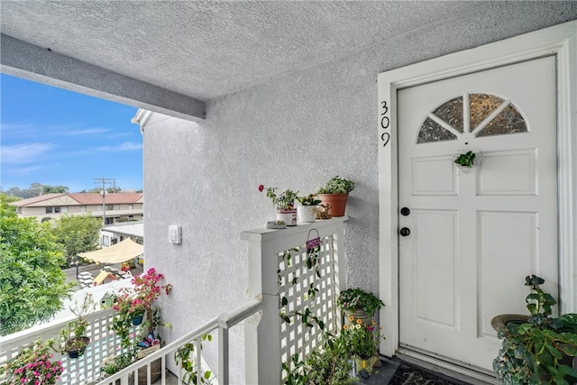 entrance to property with a balcony