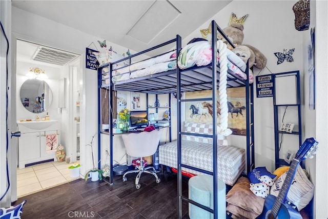 bedroom featuring wood-type flooring and sink