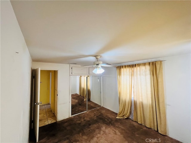 unfurnished bedroom with a closet, ceiling fan, and carpet flooring