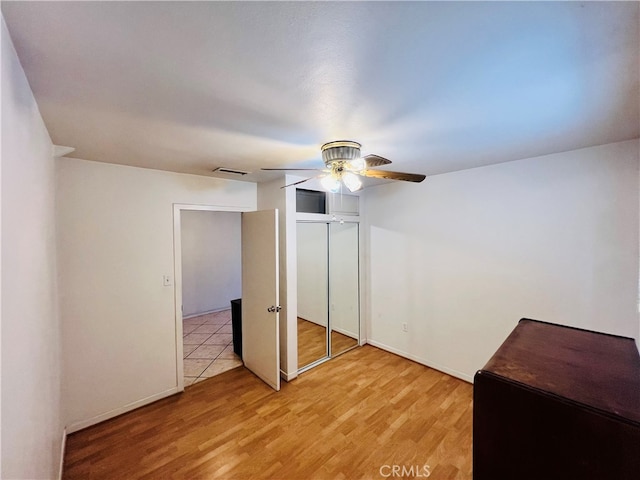 unfurnished bedroom featuring a closet, ceiling fan, and light hardwood / wood-style floors