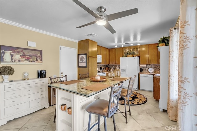 26725 Farrell St, Menifee, CA 92586 - kitchen with white appliances, light tile patterned floors, brown cabinets, ceiling fan, and a kitchen bar