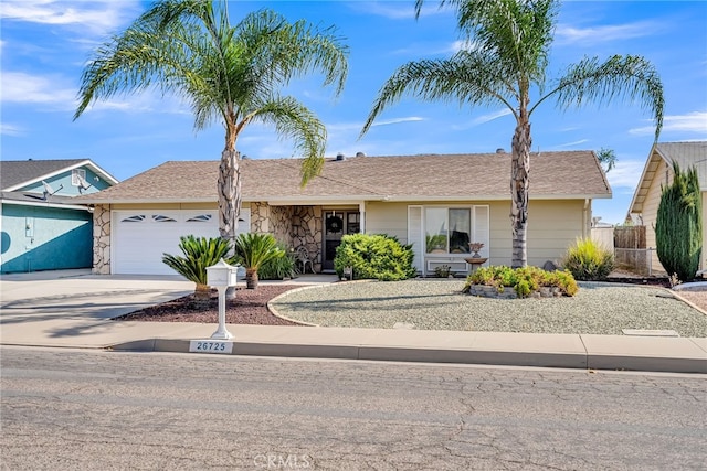 26725 Farrell St, Menifee, CA 92586 - ranch-style home featuring an attached garage, driveway, fence, and stone siding