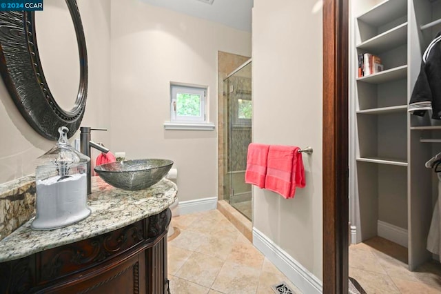 bathroom with tile patterned floors, vanity, and a shower with shower door