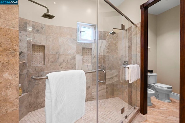 bathroom with toilet, walk in shower, and a bidet