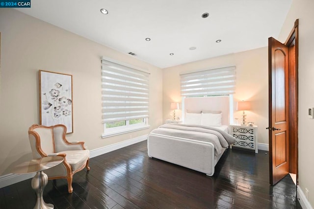 bedroom with dark hardwood / wood-style flooring