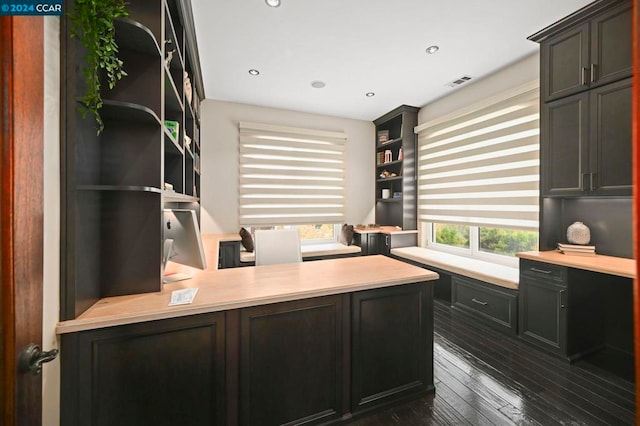 office featuring dark hardwood / wood-style flooring and built in desk