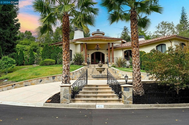 mediterranean / spanish-style house featuring a yard