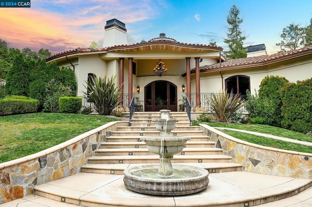 mediterranean / spanish-style house featuring a lawn