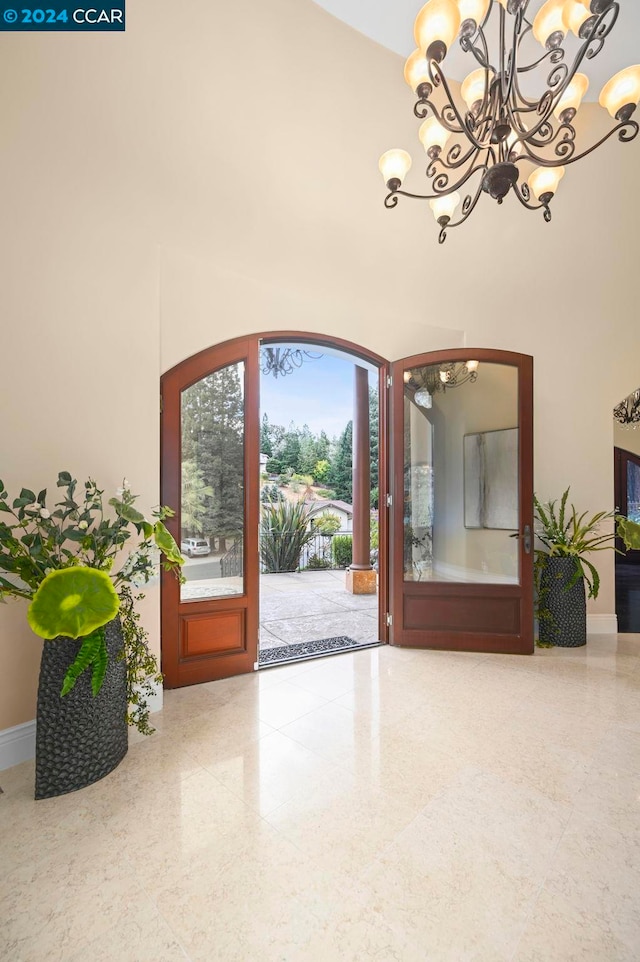 foyer entrance with a towering ceiling and an inviting chandelier