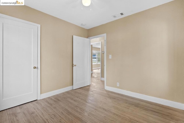 unfurnished bedroom with light hardwood / wood-style floors and ceiling fan