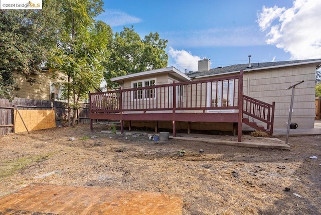 back of house with a wooden deck