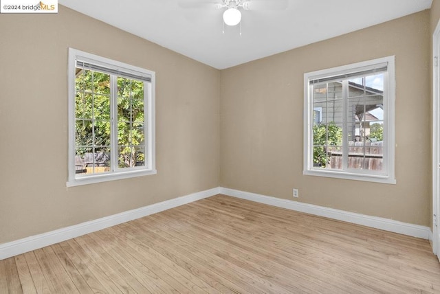 unfurnished room with ceiling fan and light hardwood / wood-style floors